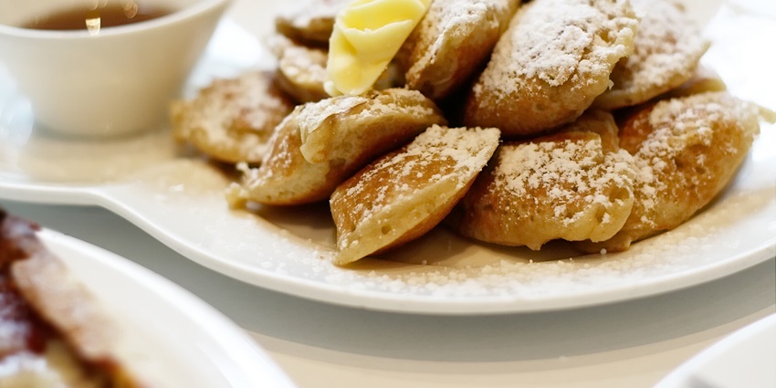 An image of Poffertjes, a pancake-like dish and an important food in Netherlands.