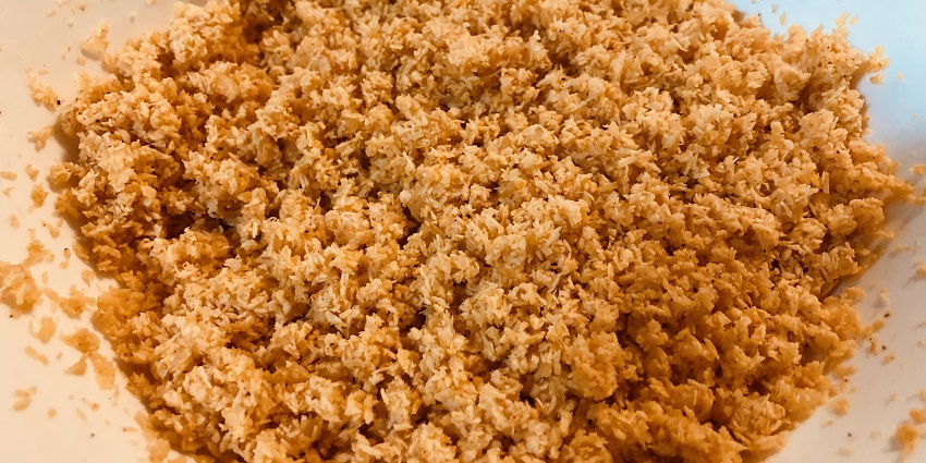 A spicy coconut, Pol Sambol, a popular street food in Sri Lanka, is served with rice.