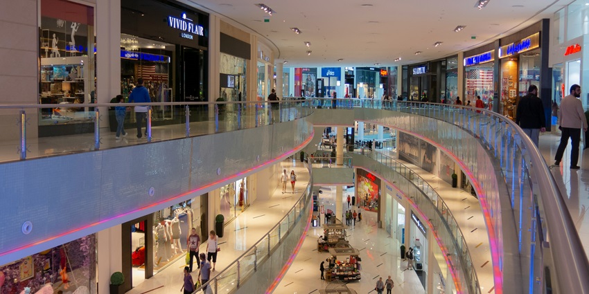 A picture of the interior of a shopping mall in Maldives with various brand stores all around