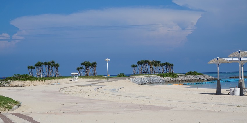 View of the soft white sands and turquoise waters at Okinawa’s peaceful Emerald Beach.