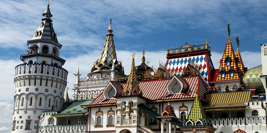Historic concrete structure with ornate towers set against a pale blue sky–places to visit near china