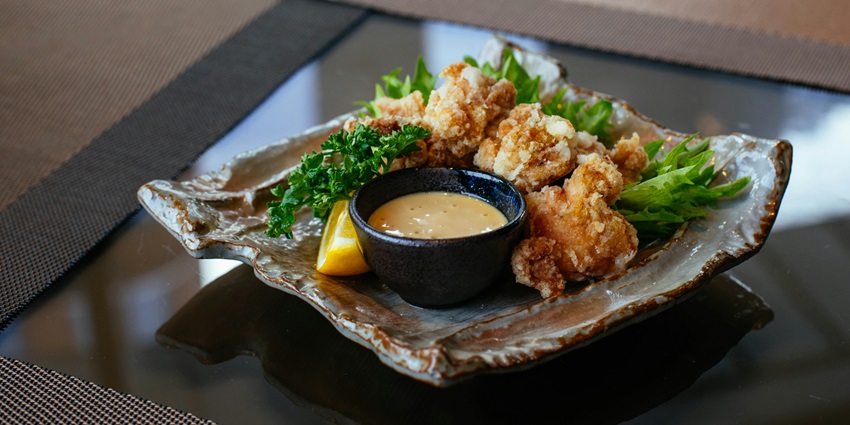 Tourists enjoying seafood served at a five-star restaurant, a fun thing to do in Hokkaido.