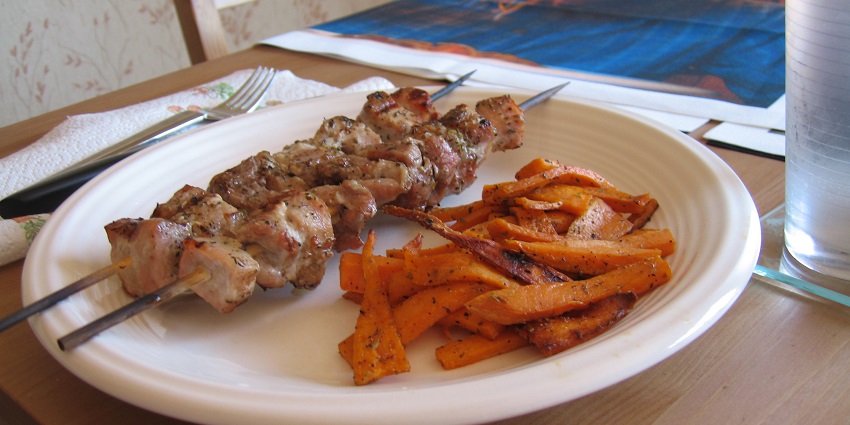 Greek souvlaki served with crispy golden potato fries on the side, ready to enjoy hot