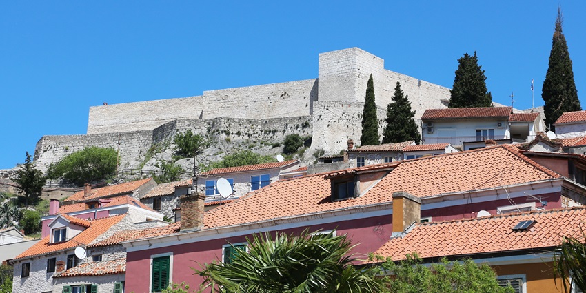 An image showing St. Michael's Fortress in Sibenik, featuring its historic stone walls and towers.