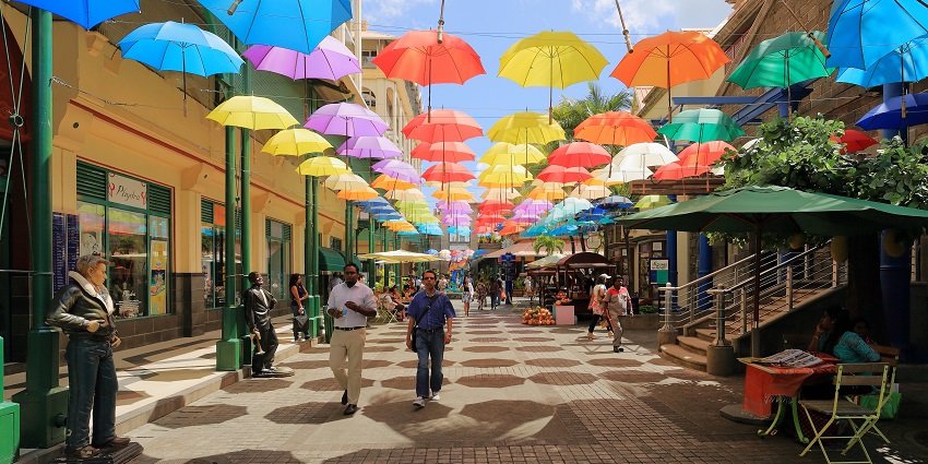 Colorful umbrellas above a walkway at Caudan Waterfront Mall in Port Louis, Mauritius.