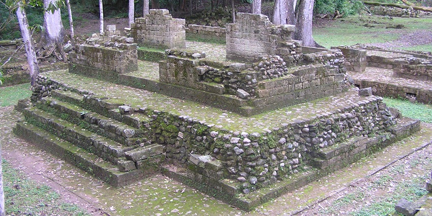 Ancient stone structures and jungle surroundings at the Rio Amarillo Archaeological Site.