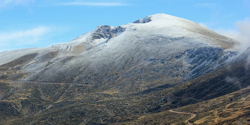 A picture of a distant snow capped mountain in Uludag, Turkey, amidst lush landscape