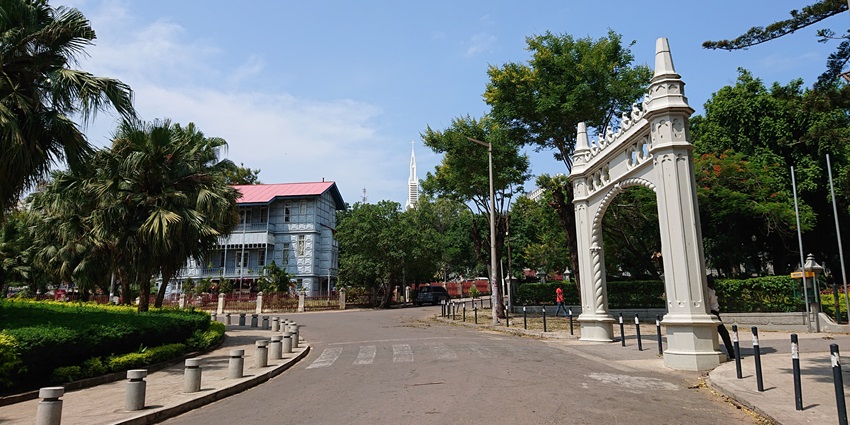 Image of the botanical garden entry front with a beautiful gate and lush flowers