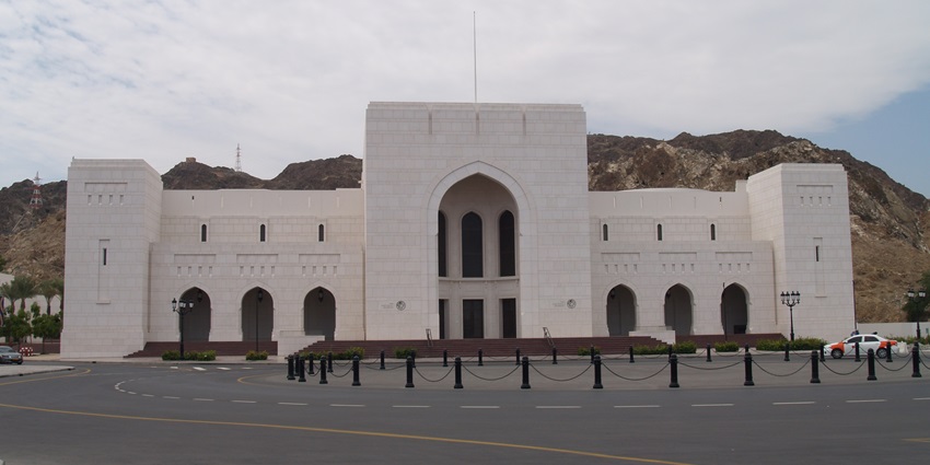 Oman National Museum at night with warm lighting highlighting its elegant architecture