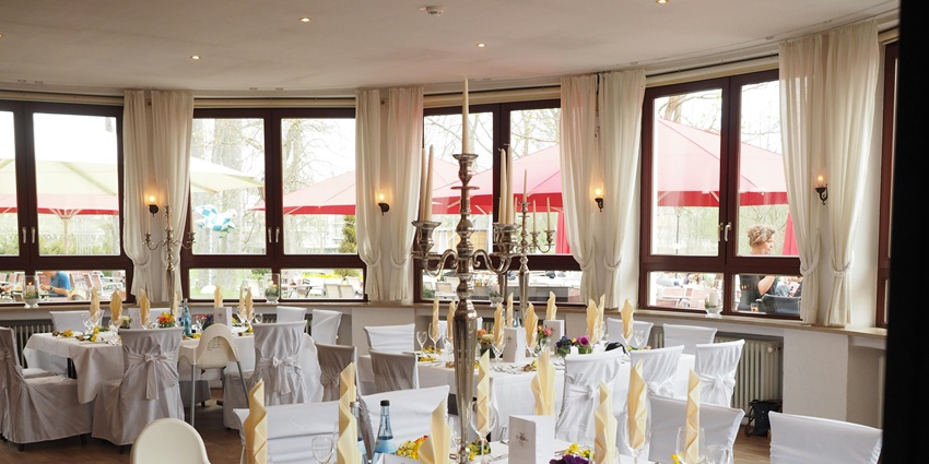 An image showing a grey candelabra as part of the table arrangement in a restaurant.