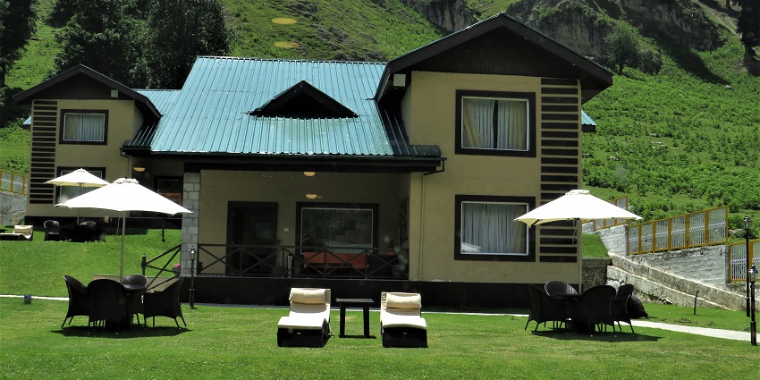Small cottage homestay in Sonamarg with the entrance gate, couple of windows and chairs