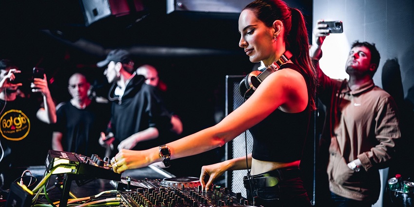 An image showing a DJ playing music at a party, similar to the atmosphere in Zouk Club