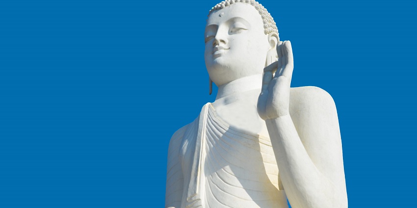 Image of the stunning Buddha statue of Sri Lanka surrounded by lush greenery