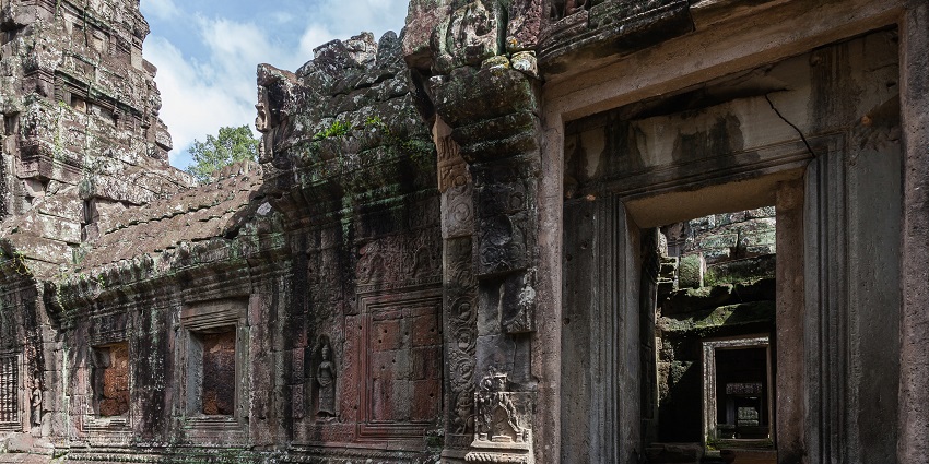 Stone carvings and towers of a serene temple complex in Angkor, Cambodia