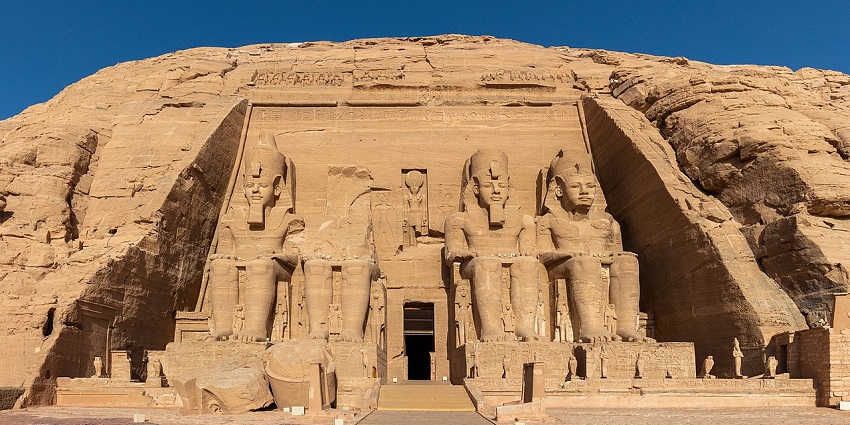 Exterior view of the beautiful Abu Simbel temples, with sunlight illuminating the facade.