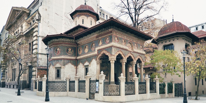 Visit Stavropoleos Monastery in Bucharest, a beautiful example of Romanian architecture.