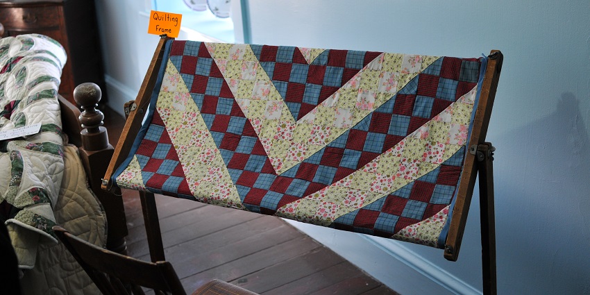 A close-up of a colorful Amish quilt with interesting patterns, displaying handmade craftsmanship and vibrant fabric designs.