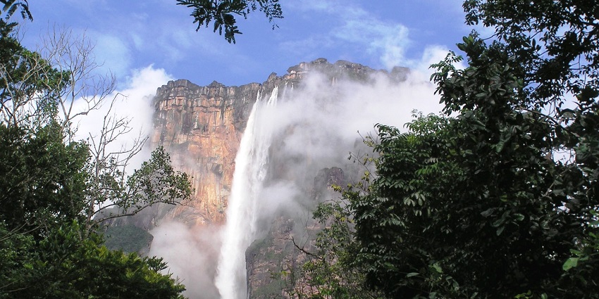 Layers of fluffy clouds hover near the Angel Falls in Canaima National Park, Venezuela
