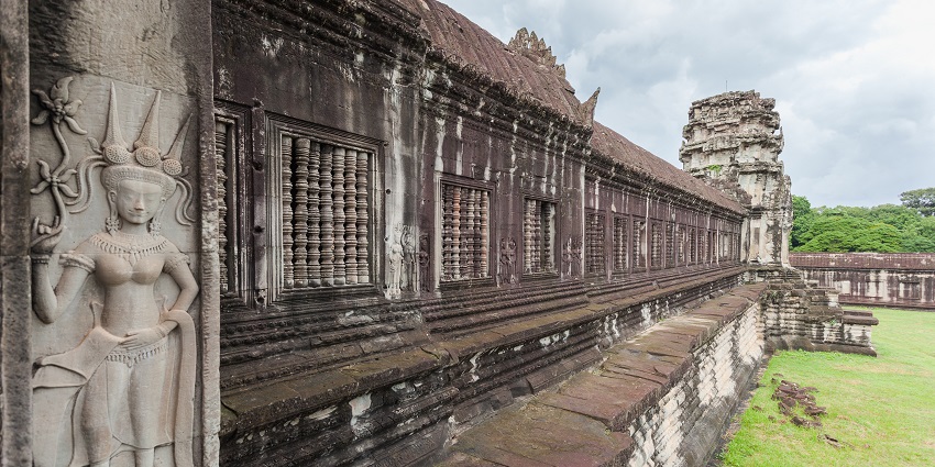 Exterior view of the majestic Angkor Wat temple with iconic towers and steps