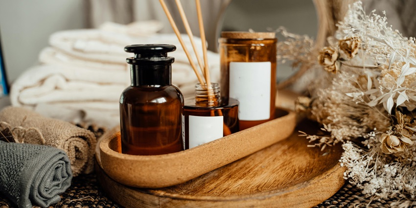 A tray with spa oils and scrubs placed beside herbal ingredients, highlighting wellness things to buy in Pattaya.