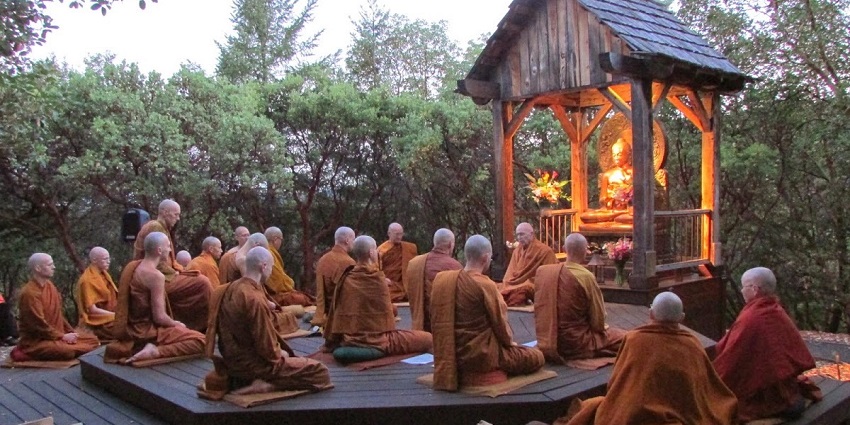 Monks and followers pray together during a traditional Buddhist ceremony in Thailand