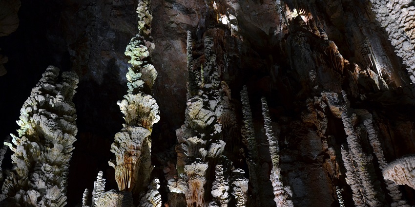 An image of Aven Armand cave showcasing impressive stalactites and stalagmites formations.