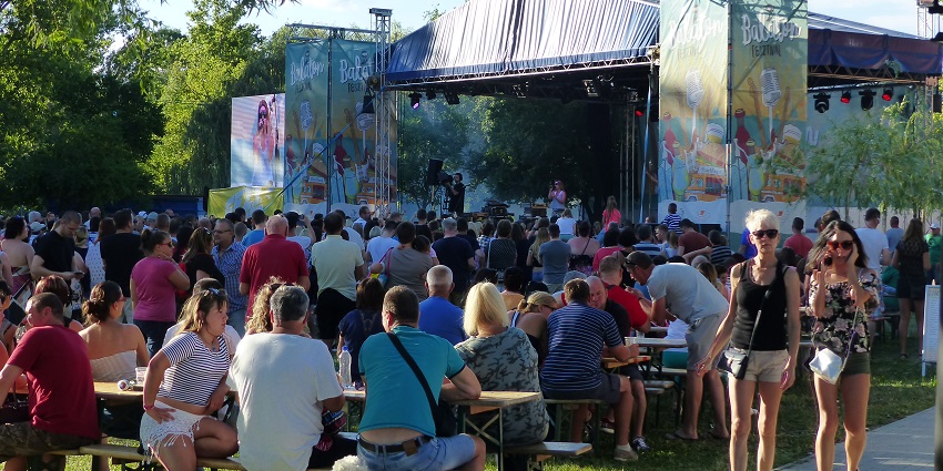 Crowd enjoying live music at the Balaton Festival in Hungary with vibrant lights and open-air stages.