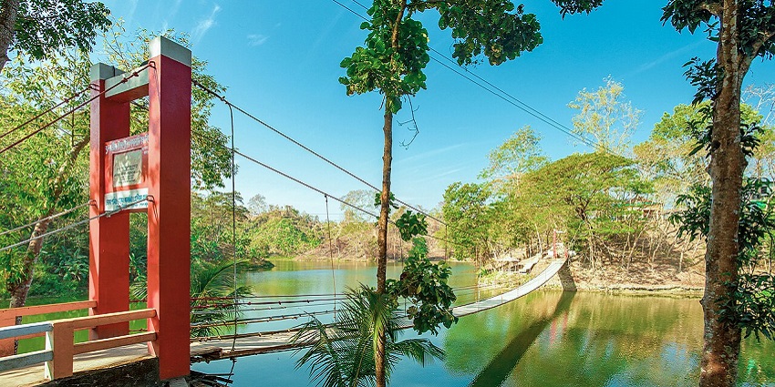 A beautiful hanging bridge along a river in the Bandarban area of Chittagong on a bright morning.