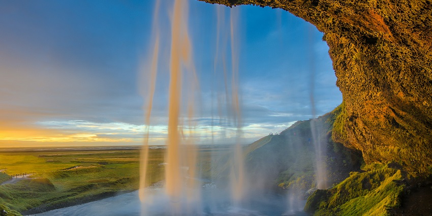 A serene view of Bang Pae Waterfall cascading from a height and forming a lagoon.