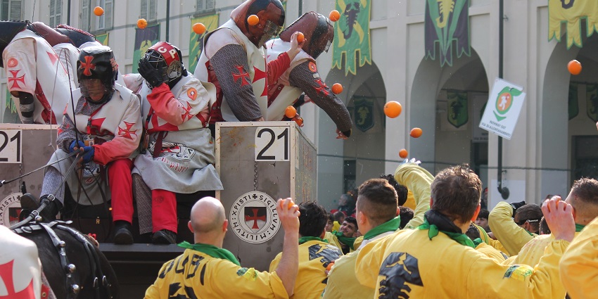 People throwing oranges in the streets during the Battle of Oranges festival in Ivrea