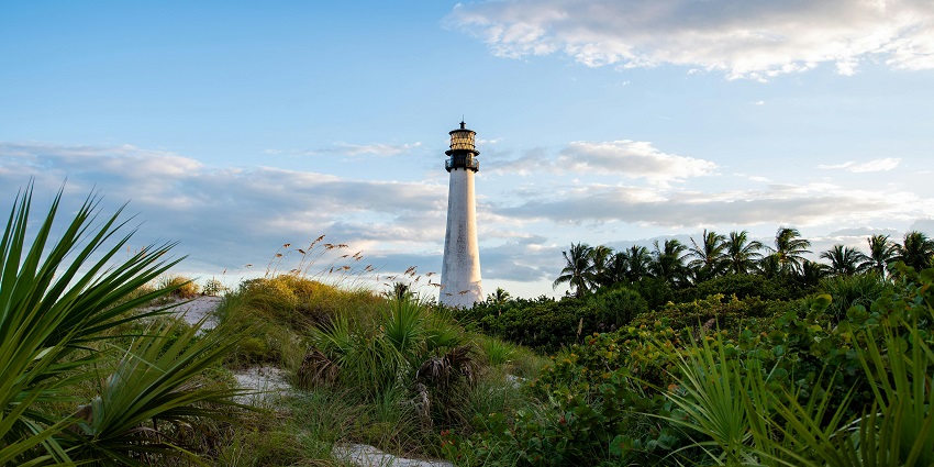 A historic lighthouse stands near the ocean in this peaceful retreat, among the top places to visit near Miami.