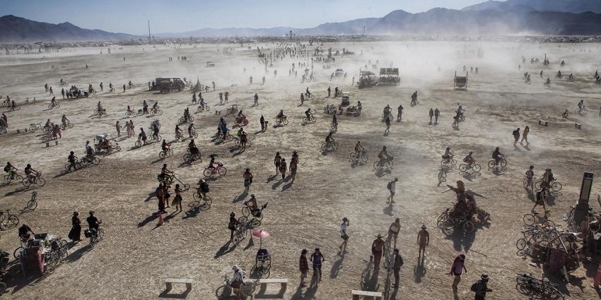Black Rock City during the burning man and people spread all around with their bikes