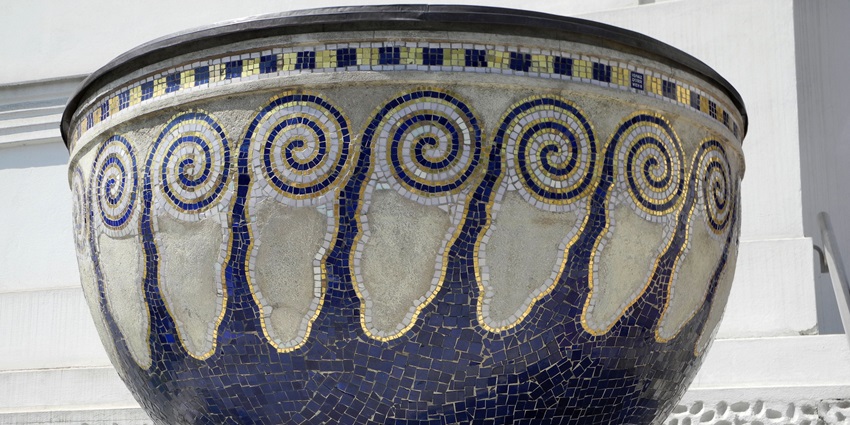 A close-up of blue ray pottery, featuring detailed patterns and a glossy finish on a ceramic piece.