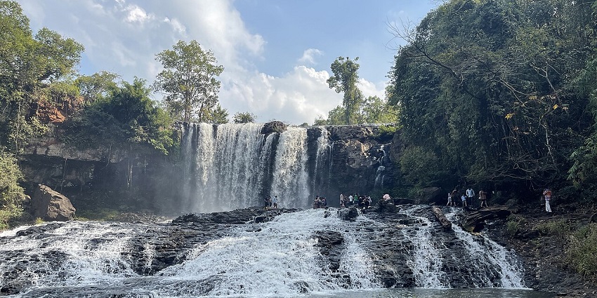 Bousra Waterfall in Cambodia surrounded by dense jungle and scenic landscapes.
