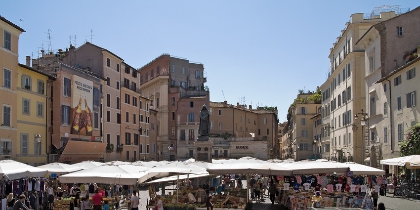 People shopping at a bustling market, which is one of the best things to do in Rome in October