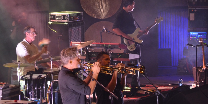People in a band performing a live jazz performance alongside their band members.