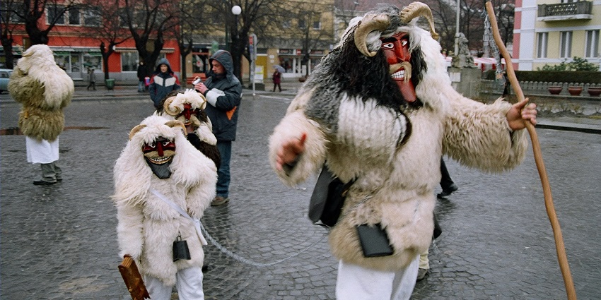 People in traditional Busó costumes parade through Mohács, Hungary, celebrating Carnival by symbolically chasing winter away.