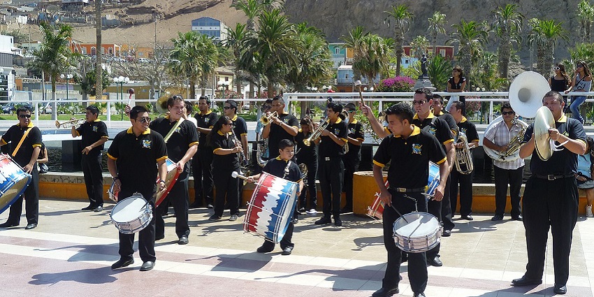 Musicians and dancers perform through Arica’s streets during the Andean Carnival.