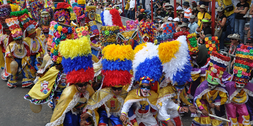 Performers in feathered and beaded costumes lead a parade during Barranquilla Carnival, one of the most famous festivals in Colombia.