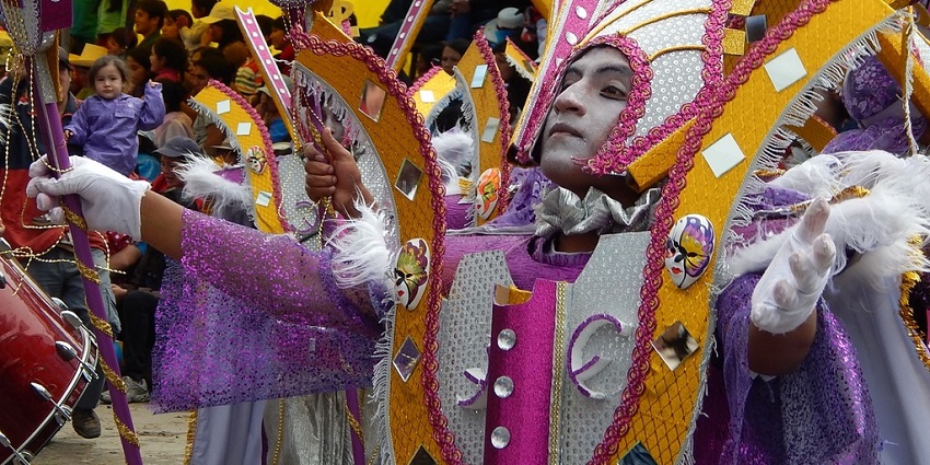 Dancers in masks adorned with sequins and paint perform at Peru’s vibrant Carnaval de Cajamarca.