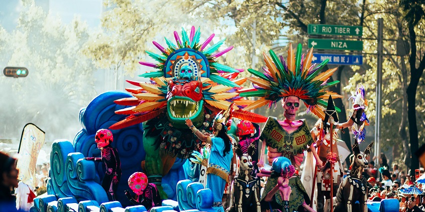 People in brightly coloured monster and wrestler costumes, celebrating festivals in Mexico