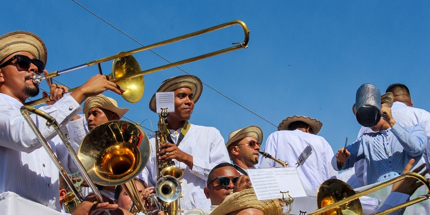 A group of artists play trumpets while performing a Murga at a Carnival in Las Tablas, Panama