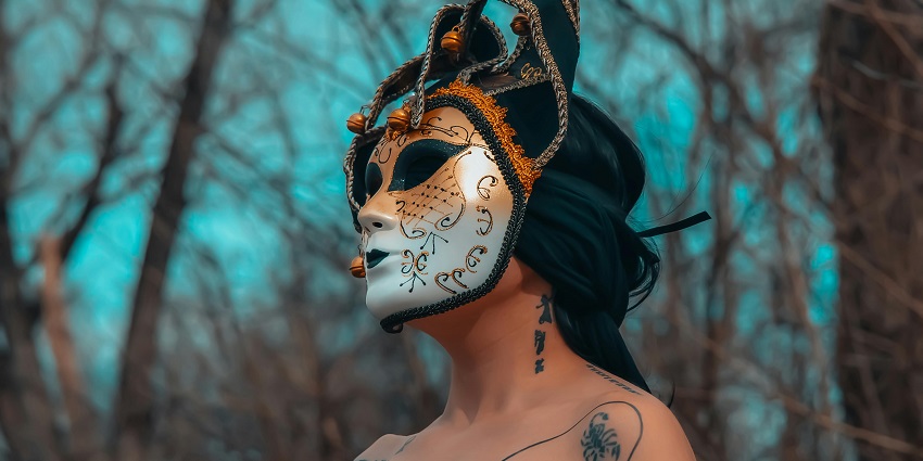 A woman with body art with a golden and white mask, at one of the festivals in Argentina.