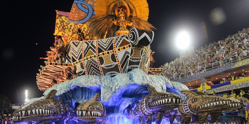 Vibrant display in the parade of samba schools with people all around in the Carnival
