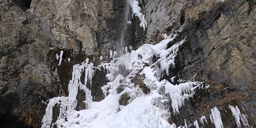 Cascade de Saint-Benoît with frozen water, with little water flowing down the cliff