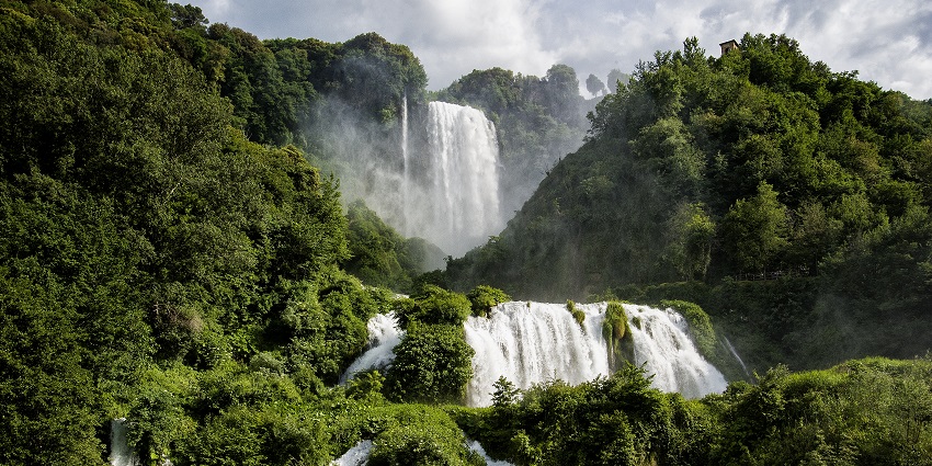 Cascata delle Marmore waterfall cascading through dense greenery and vibrant trees