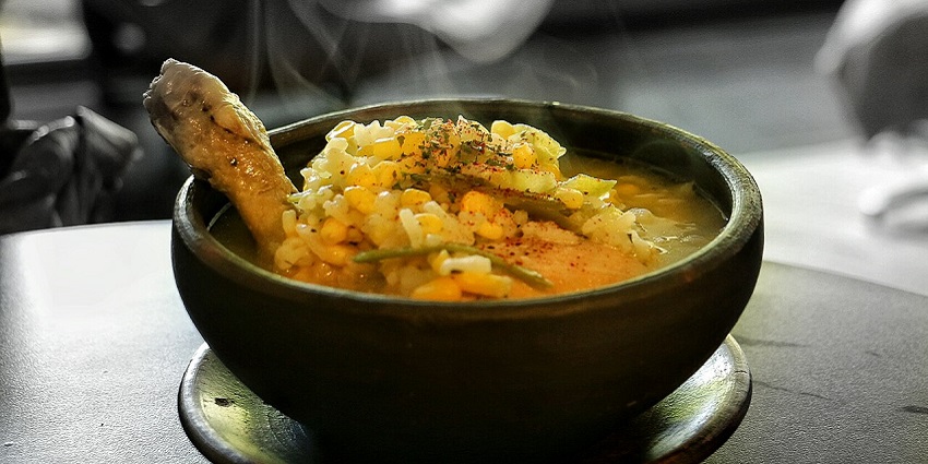An image of Cazuela, a Chilean soup with meat, potatoes, and vegetables in broth.