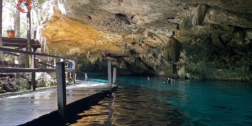 An image of crystal-clear blue water inside Cenote Dos Ojos, caves in Mexico.