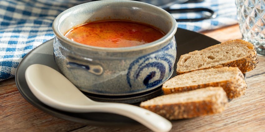 An image showing Česnečka, a famous garlic soup which is the best food in Czech Republic.