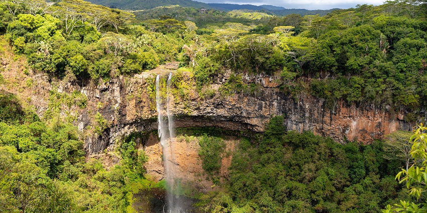 Majestic Chamarel Waterfall cascading down a lush green cliff in southwest Mauritius